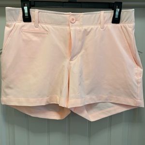 Peach/pink Under Armour women’s golf shorts